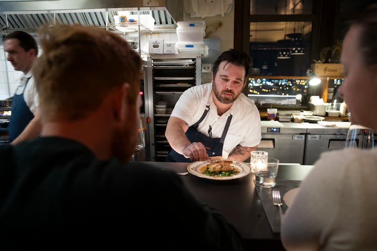 Chef Michael Ferreri presents the Snapper course to Jack Rosenberg and Alexis Caris, from Graduate Hospital, during the Salvatore’s Counter tasting menu at Irwin’s in the Bok Building in Philadelphia, Pa. on Sunday, March 3, 2024. Salvatore’s Counter is a 10-course dinner for up to 4 diners near the kitchen pass at Irwin’s. Each course is prepared by Ferreri.