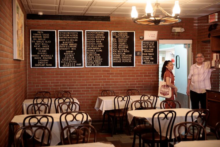 Local artist Michelle Angela Ortiz (left) and Epiphany De Luca at De Luca’s Villa di Roma restaurant in Philadelphia on Saturday, June 15, 2024. Ortiz is collecting stories of the immigrant/migrant vendors, business owners, and neighbors that work and reside in the Ninth Street Market for a community building public art project titled Our Market. Epiphany De Luca is already a part of the Our Market project.