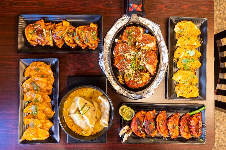 A table with Jhol Momo, Tandoor Chicken Momo, Chicken Choyal Momo, Goat Tikka Momo, Himalayan Chilly Momo, and Jimboo Le Janeko served at Nepali Momo Kitchen in Philadelphia, Pa., on Thursday, Jan. 18, 2024.