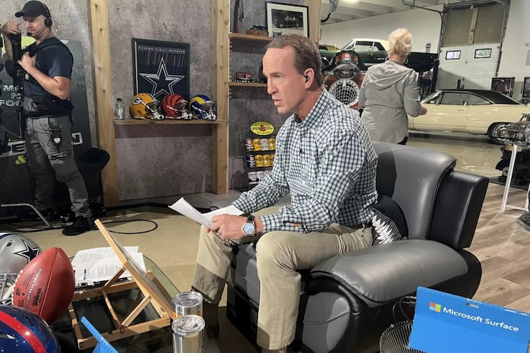 Peyton Manning works in his makeshift studio in a friend's vintage car garage in Denver. 