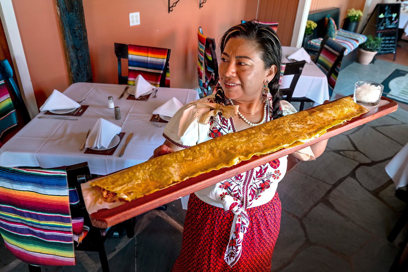 Chef owner Claudia Vazquez-Altone with the mega-machete at Los Machetes in Ocean View, N.J.