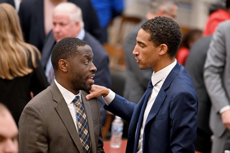 Councilmember Isaiah Thomas (left) talks with Sixers official David Gould (right) in chambers following the morning session Wednesday, on the second day of Council's hearings on the 76ers arena proposal. Gould is chief diversity and impact officer with Harris Blitzer Sports & Entertainment, which owns and operates the Sixers.