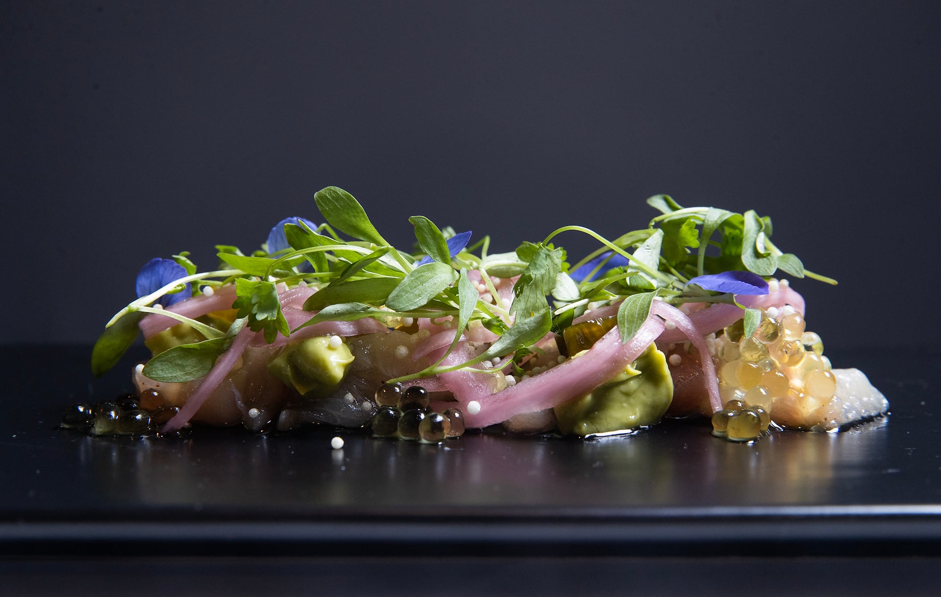 The hamachi crudo, with a lemongrass emulsion, crunchy rice crisps, and mango-flavored “caviar,” at Chanterelle in Stone Harbor.