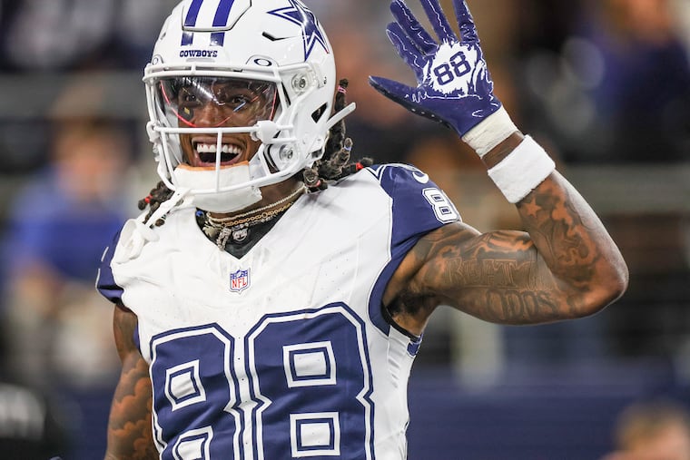 Dallas Cowboys wide receiver CeeDee Lamb waves while celebrating in the end zone after a first quarter touchdown against the Eagles at AT&T Stadium on Sunday, Dec. 10, 2023.