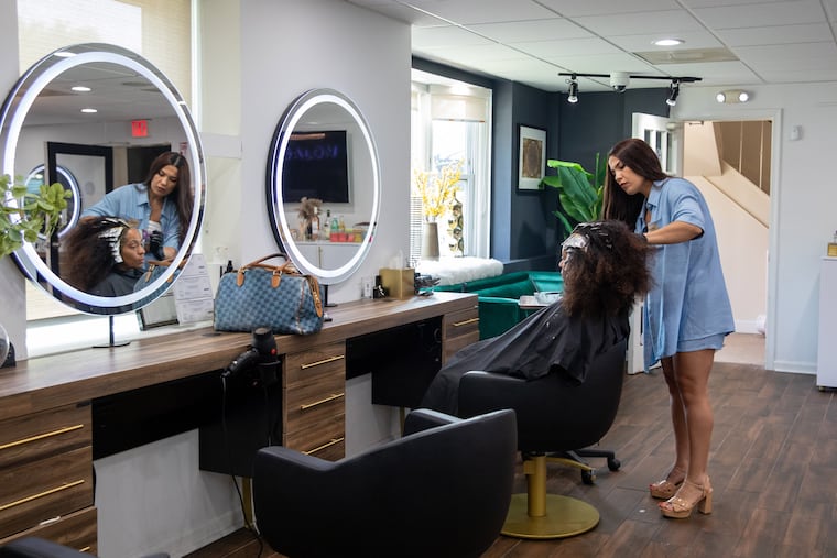 Tuba Sim works on Joanne Robinson's hair at Salon Simis in Fairfax, Va., in this file photo.