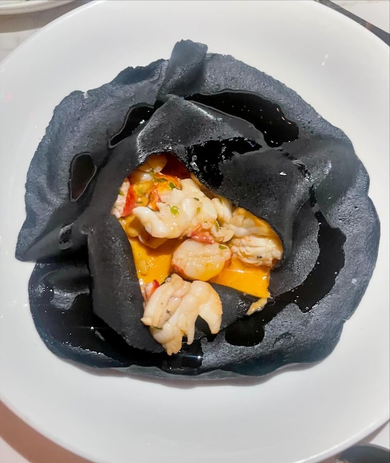 A squid ink crepe at Illata hides lobster in sauce Americaine underneath.