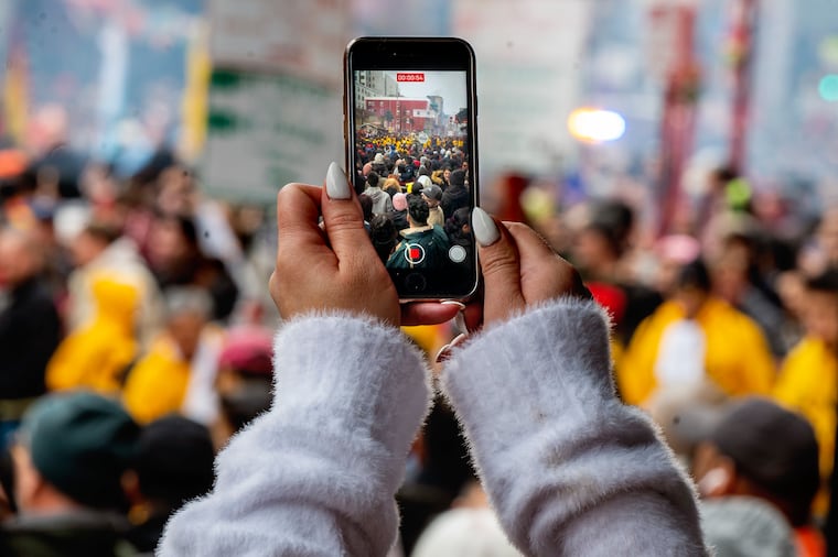 Spectators photograph as the Year of the Dragon kicks off in Chinatown in 2024.