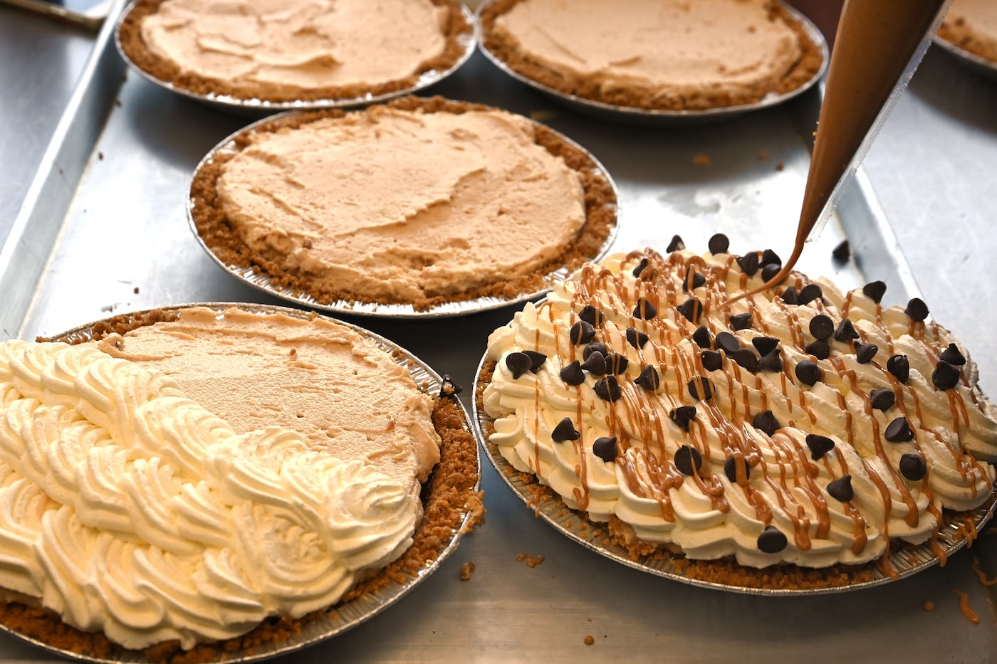 Jenna Kisby drizzles peanut butter to finish off a chocolate peanut butter pie at Kizbee’s Kitchen in Egg Harbor City.