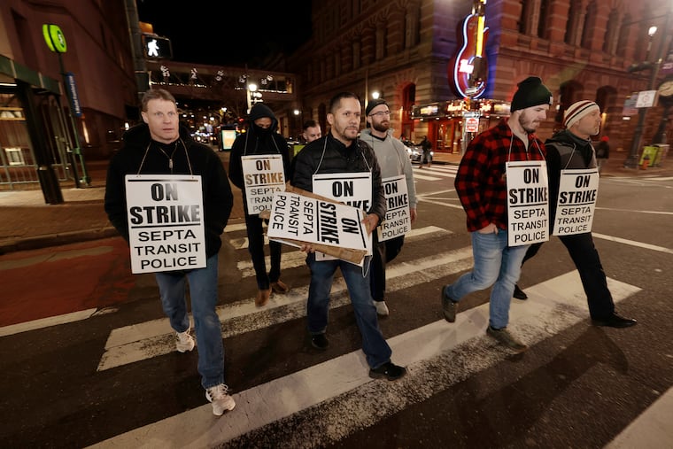 Fraternal Order of Transit Police FOP Lodge 109 members walk to SEPTA headquarters after going on strike in Philadelphia on Dec. 13, 2023.