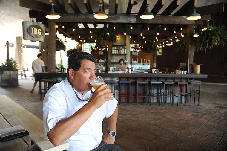 Mike Yip, 55, Folsom, NJ, has the official first beer at the new Independence Beer Garden which overlooks Independence National Historic Park on 6th Street between Market and Chestnut Sts. ( CLEM MURRAY / Staff Photographer )