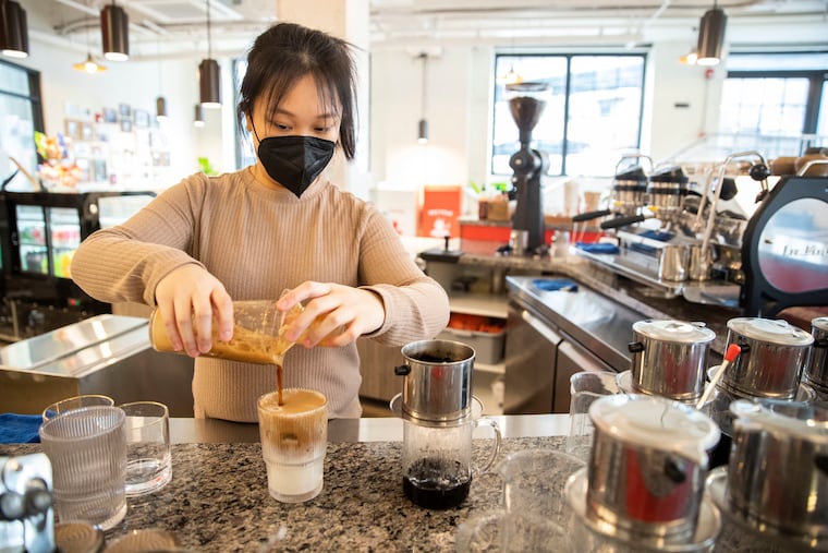 Barista Dana Huynh prepares a Bac Xiu, a shaken espresso latte, at Càphê Roasters, a Vietnamese specialty coffee roastery.