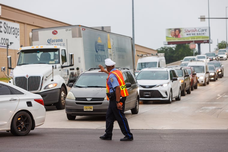 A Philadelphia police officer directs traffic exiting I-95 southbound at the Cottman Ave. exit. 