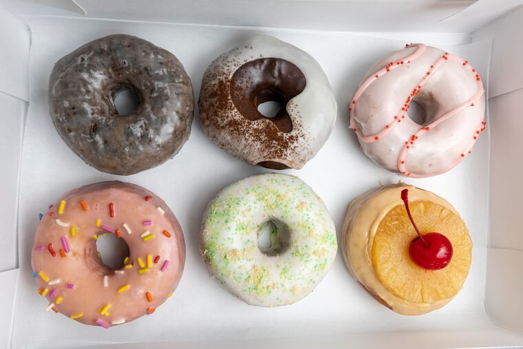 Vegan chocolate, Mexican hot chocolate, and strawberry rhubarb doughnuts above birthday cake, key lime pie, and pineapple upside-down doughnuts from Okie Dokie Donuts in Philadelphia, Pa., on Friday, April 5, 2024.