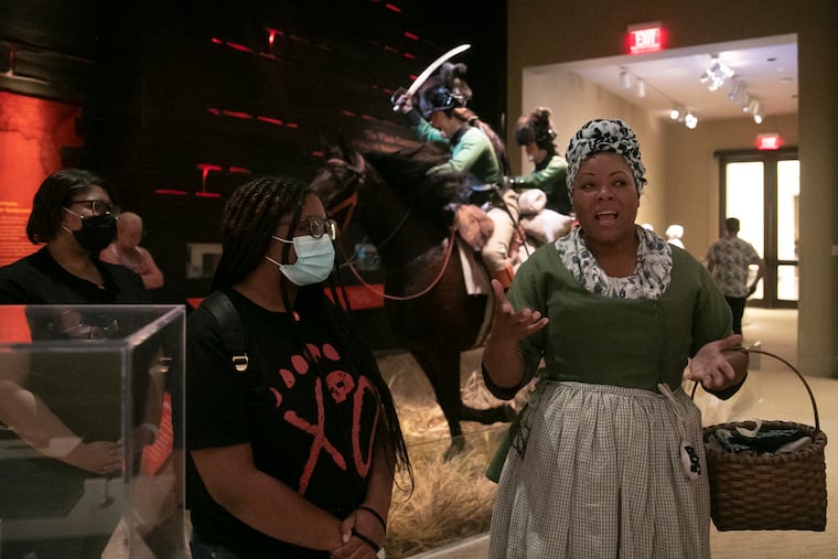 Brenda Parker, a historical interpreter, speaks to visitors at the Museum of the American Revolution.