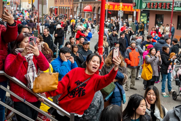 Spectators photograph as the Year of the Dragon kicks off in Chinatown at 2024's Lunar New Year’s Day Parade. 