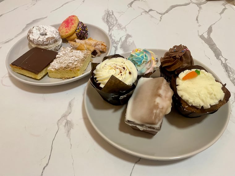 A selection of sweets from the Happy Mixer Gluten Free Bakery, a local gluten-free bakery chain in Philadelphia's northwestern suburbs. Shown here, are (clockwise from bottom of top plate) a peanut butter delight, cream-filled doughnut, a sugar cookie, a chocolate-dipped cookie stuffed with rasberry jam, jelly-filled kiffles and a crumb cake. On bottom plate (clockwise from bottom): mini-lemon pound cake, red velvet cake muffin, cupcakes and carrot cake muffin.