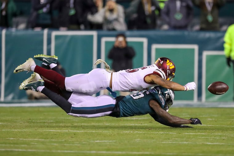 Washington cornerback Benjamin St-Juste forces a fumble by Eagles wide receiver Quez Watkins during a 32-21 Commanders win last November.  