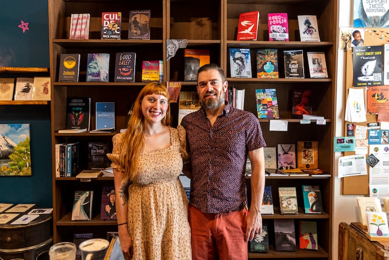 Alex Schneider, 39, and Christina Rosso-Schneider, 32, of Drexel Hill, owners of A Novel Idea bookshop, pose for a portrait in their shop in South Philadelphia, Pa., on Wednesday, July 12, 2023.