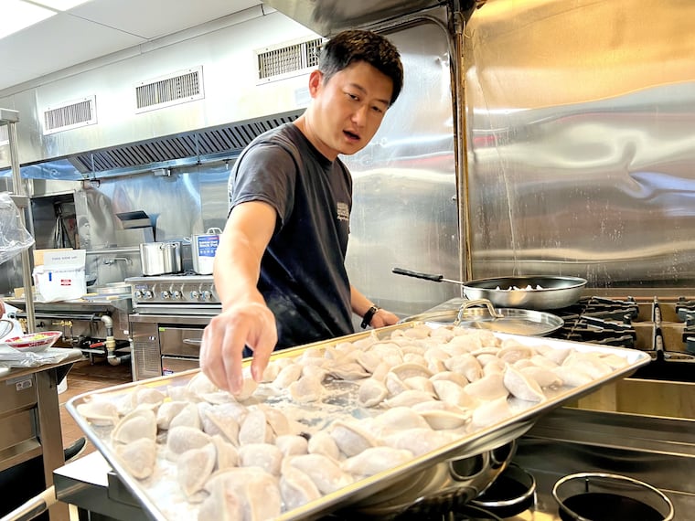 Luscious Dumplings owner Ker Zhu cooking dumplings at the restaurant, 937-939 Race St., on June 13, 2024.