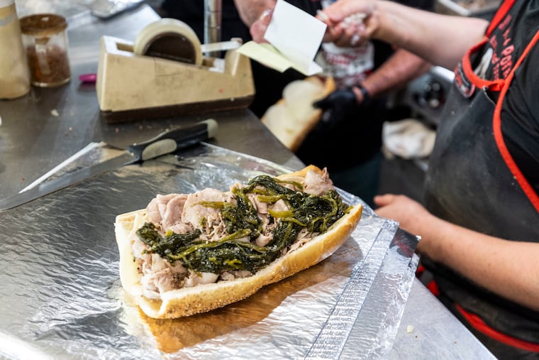 A roast pork sandwich with spinach at John’s Roast Pork.