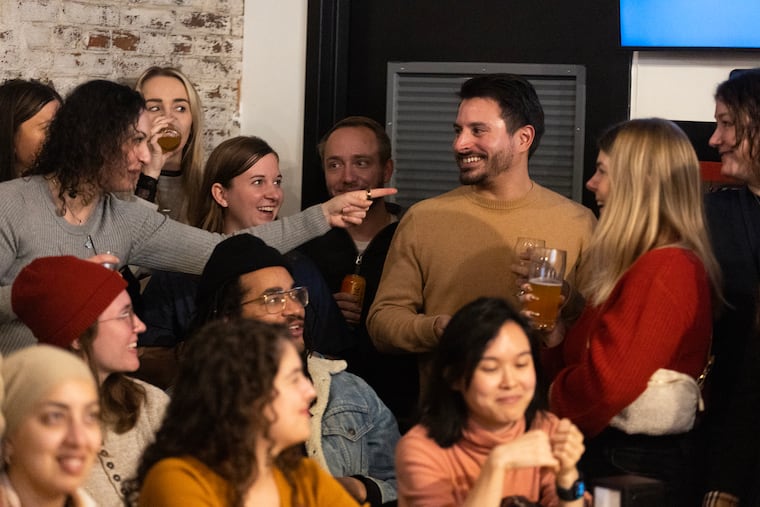 Philly Pitch-A-Friend attendees react after a presentation on Rich D'Antonio (center) at an event at Meyers Brewing.