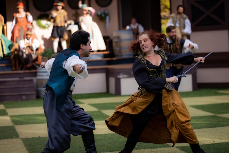 Cast members duel with swords during a fight in the Tournament of Arms.