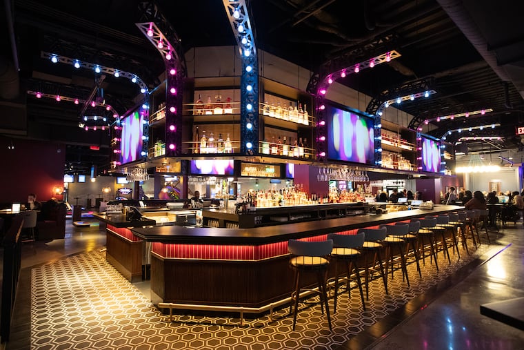 Puttshack is a new "upscale tech-infused mini-golf experience" opening in Liberty Place in Center City Saturday It's the second of indoor mini-golf bar-restaurant to open in a two-mile radius since 2021. The bar area is shown during a preview evening on Feb. 20, 2024.